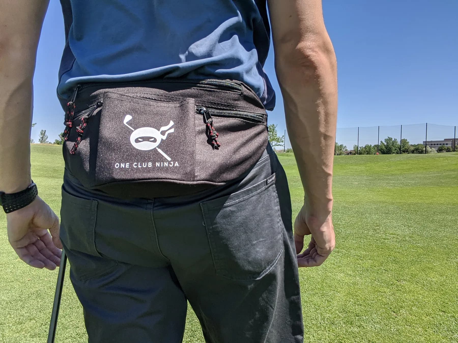 The One Club Ninja waist bag worn on a par 3 course