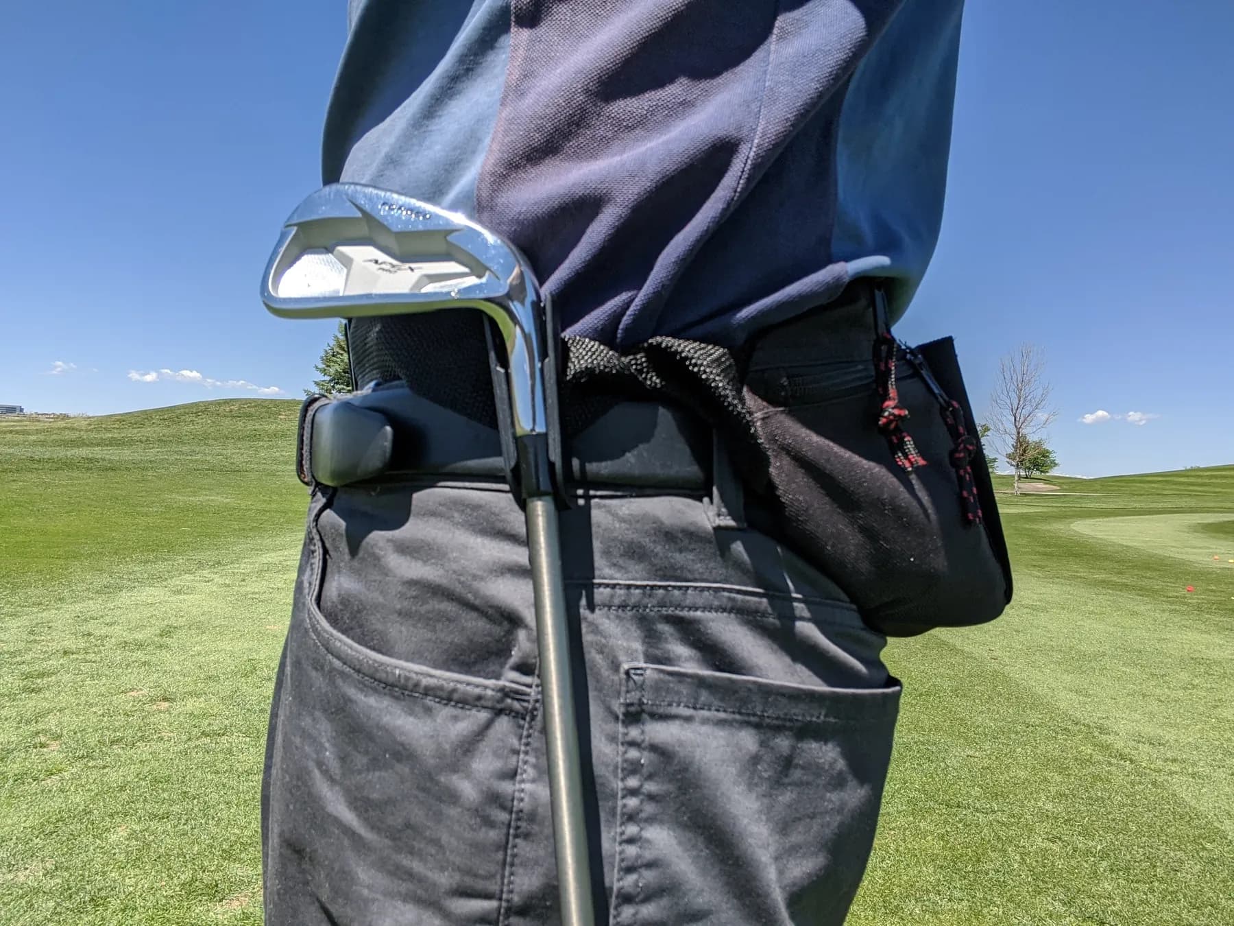 A 7-iron holstered in the One Club Ninja waist bag on the course
